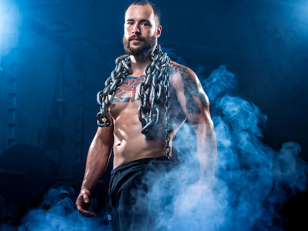 Matt Cookson wearing training chains in his original blue-lit portrait