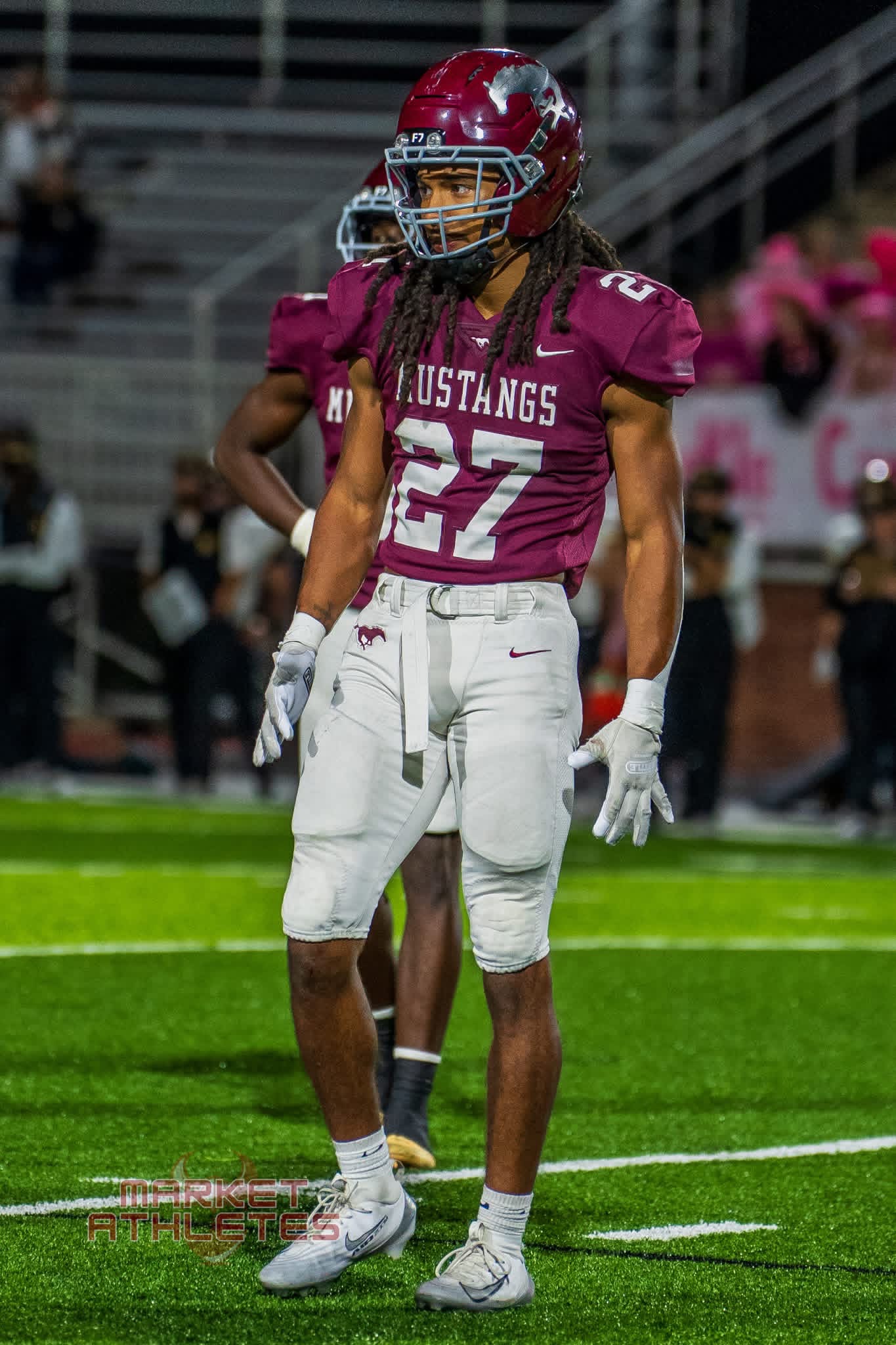 Football athlete wearing number 52 on the field